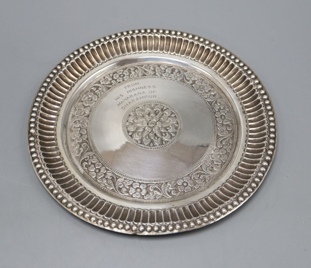 An Indian white metal salver, with floral decoration inscribed from His Highness Maharana of Dharampur, diameter 21.5cm